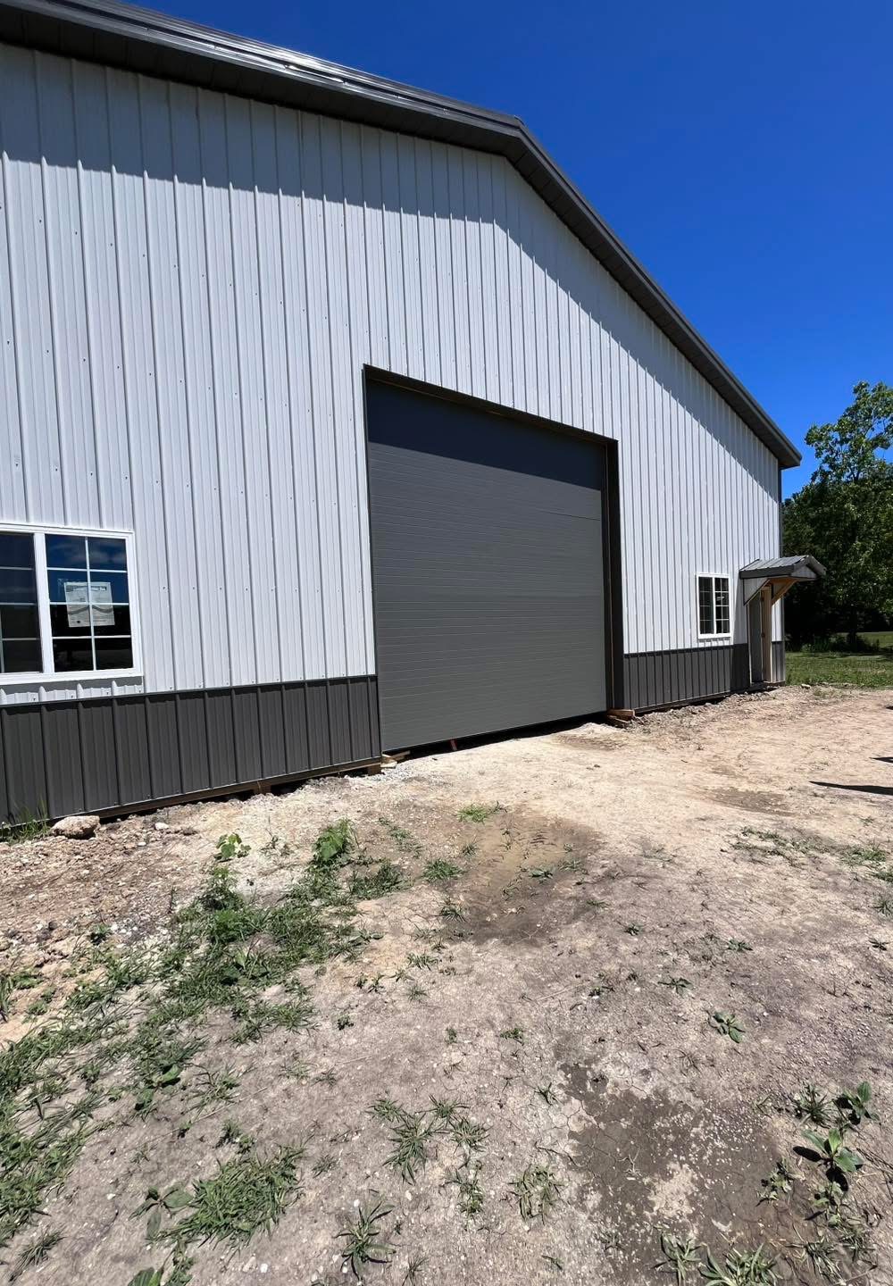 Dark overhead door installed on a pole barn