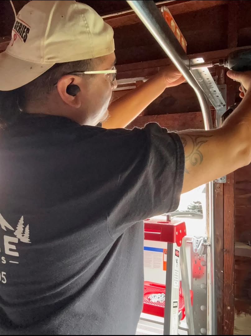 Daniel working on garage door hardware