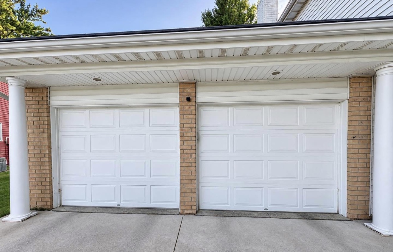 Pair of white single garage doors