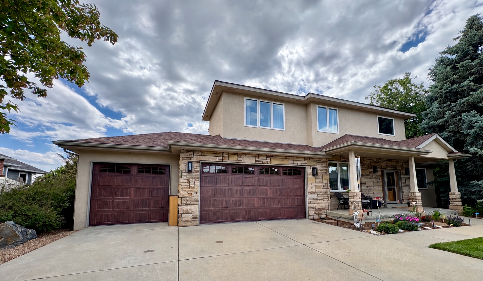 Brown wood-look three-door residential installation by Alpine Garage Doors